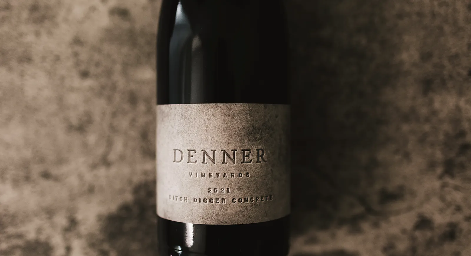 Denner Vineyards Non Club Ditch Digger Wine bottle laying on concrete.